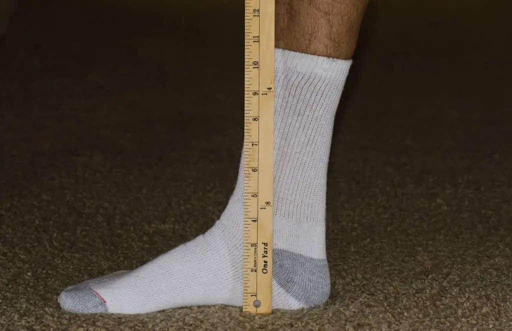 measuring socks with a tape meausre